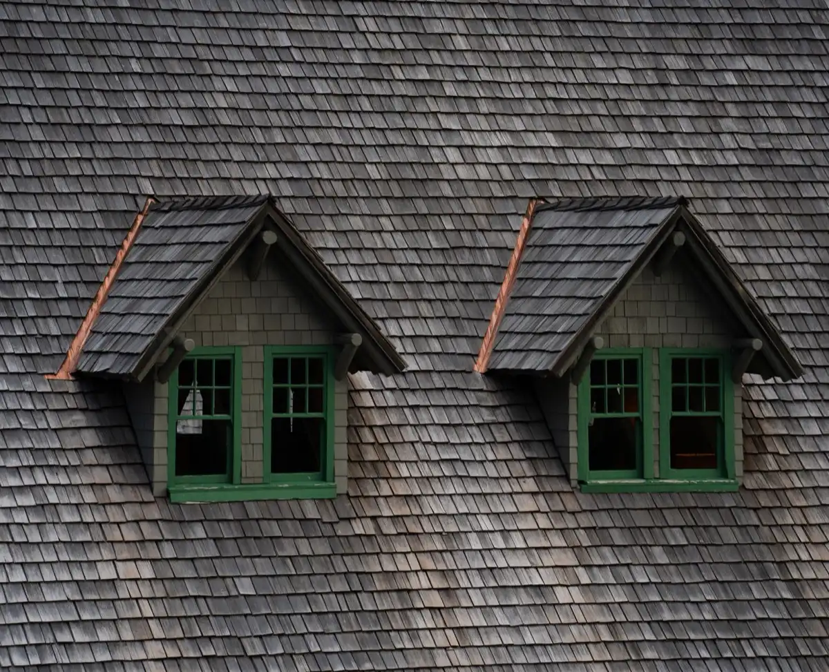 Dormers on a shingle roof in Kokomo, IN, where step flashing and kickout flashing carry water past the walls